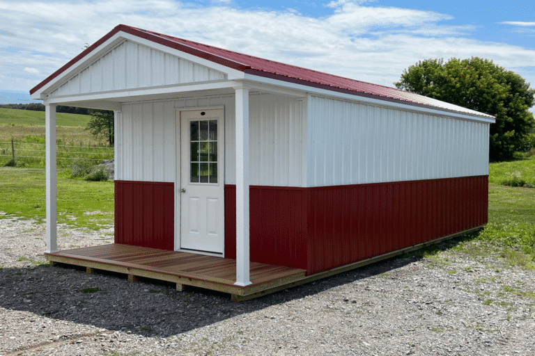 white and red 12x14 cabin with red metal roof and front porch in new york