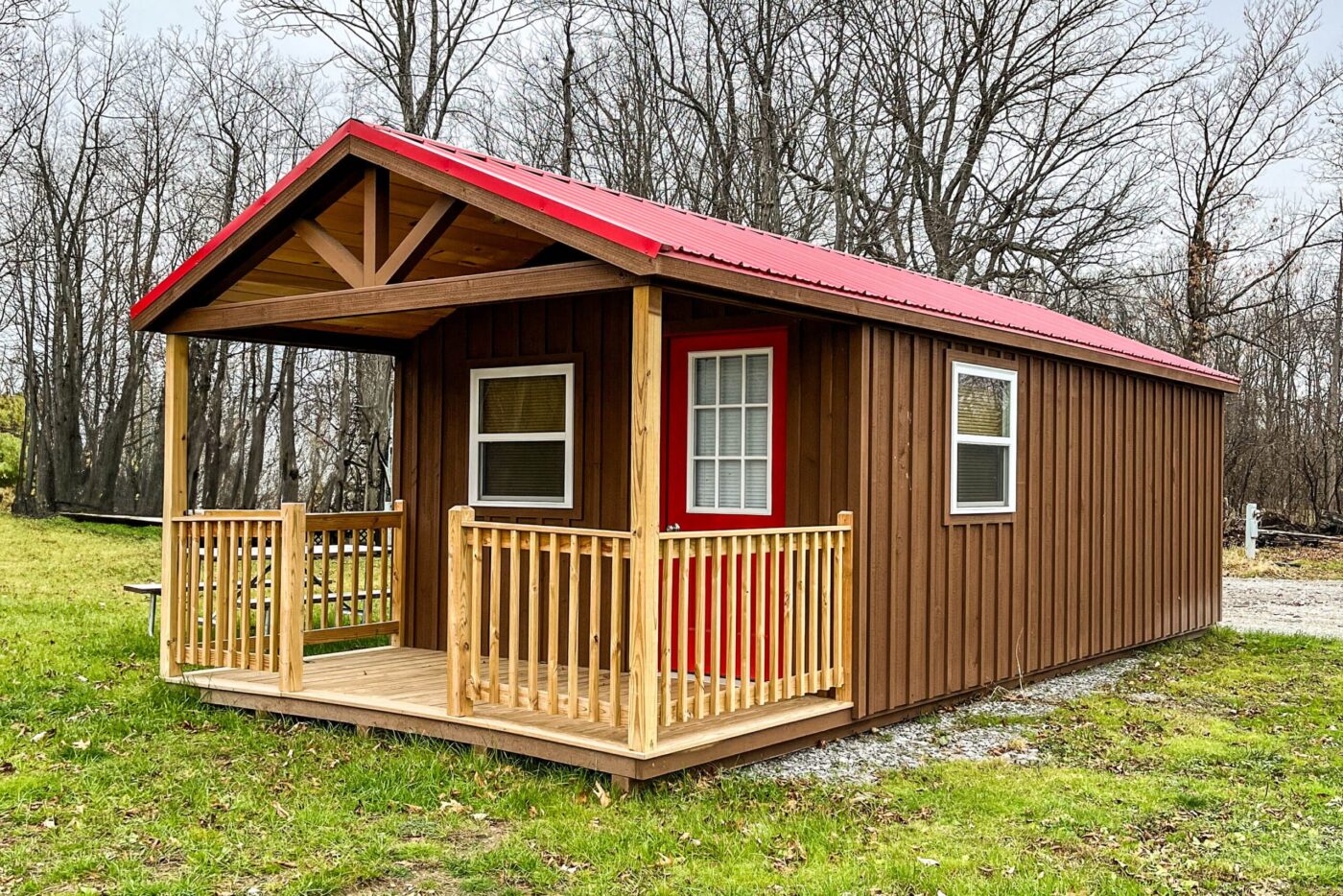 brown and red 14x24 cabin with a gable porch and windows in new york