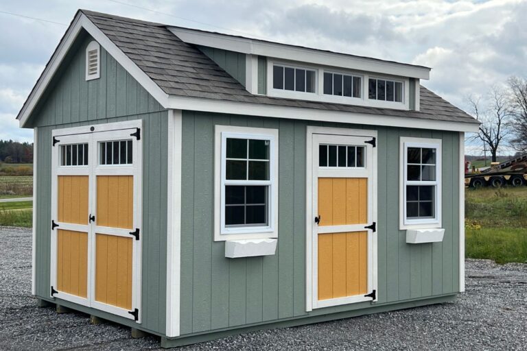 One of our chalet sheds near Cheektowaga NY - Gray green wood with white and mustard colored white trimmed doors - white trimmed windows and gray roof
